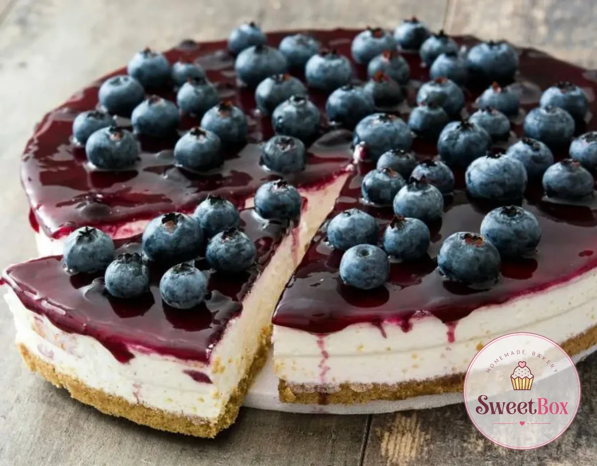 Sliced blueberry cheesecake with a glossy blueberry topping and fresh blueberries