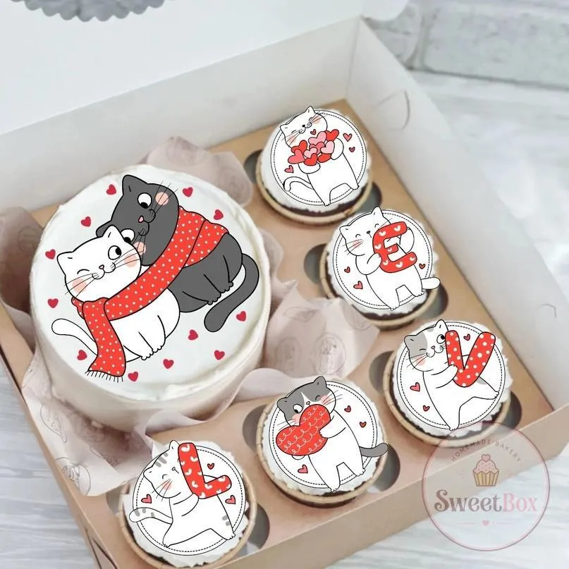 Gift box with a cuddling cats bento cake and cupcakes with cat prints spelling LOVE
