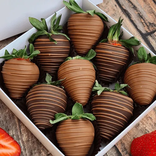 Box of strawberries dipped in milk chocolate and drizzled with dark chocolate stripes
