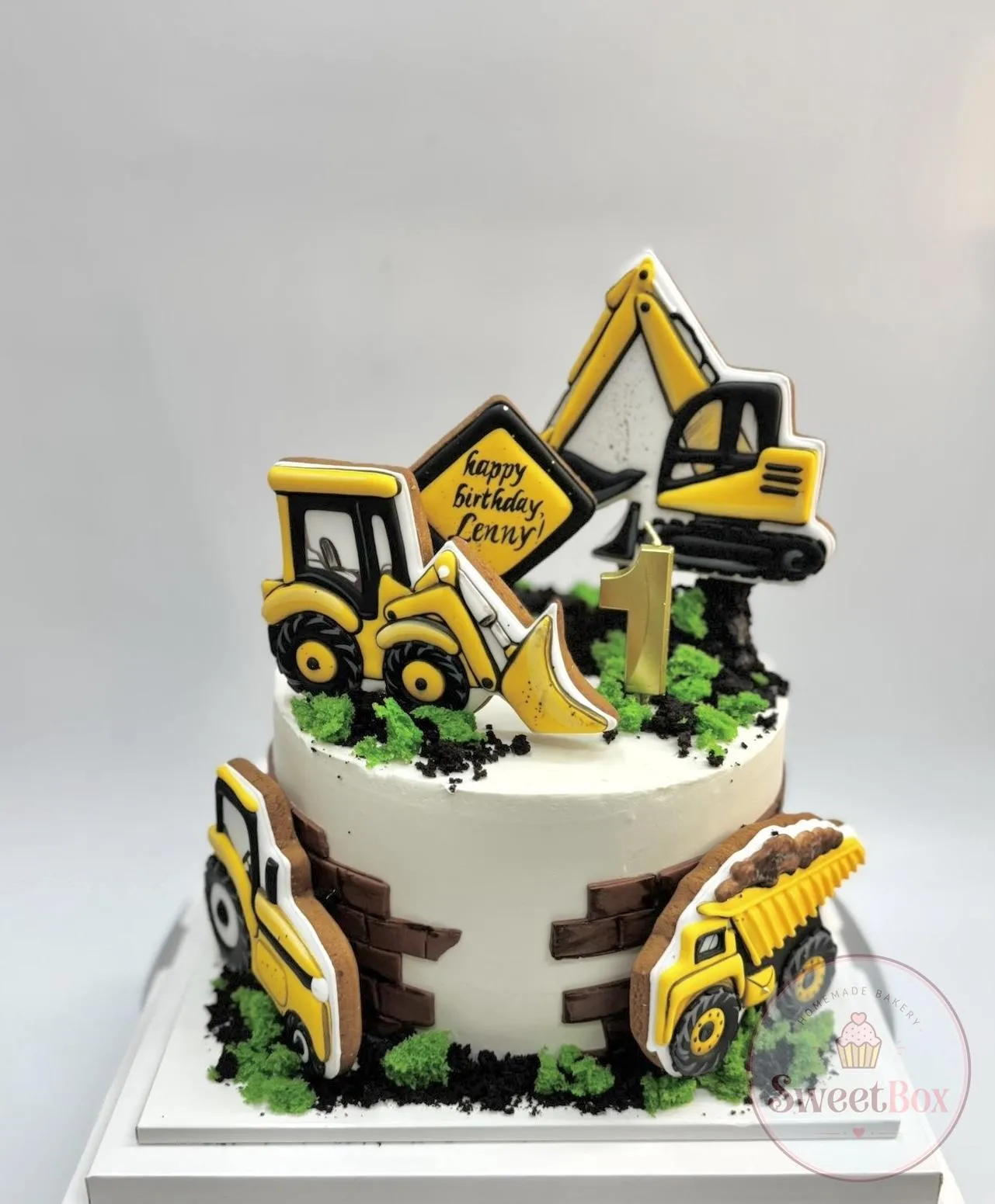 Construction theme birthday cake with excavator, bulldozer and dump truck cookies