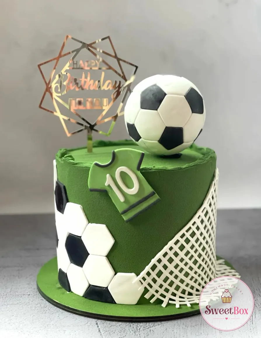 Green football cake with fondant hexagons, a number 10 jersey, a white net, a soccer ball and a Happy Birthday topper