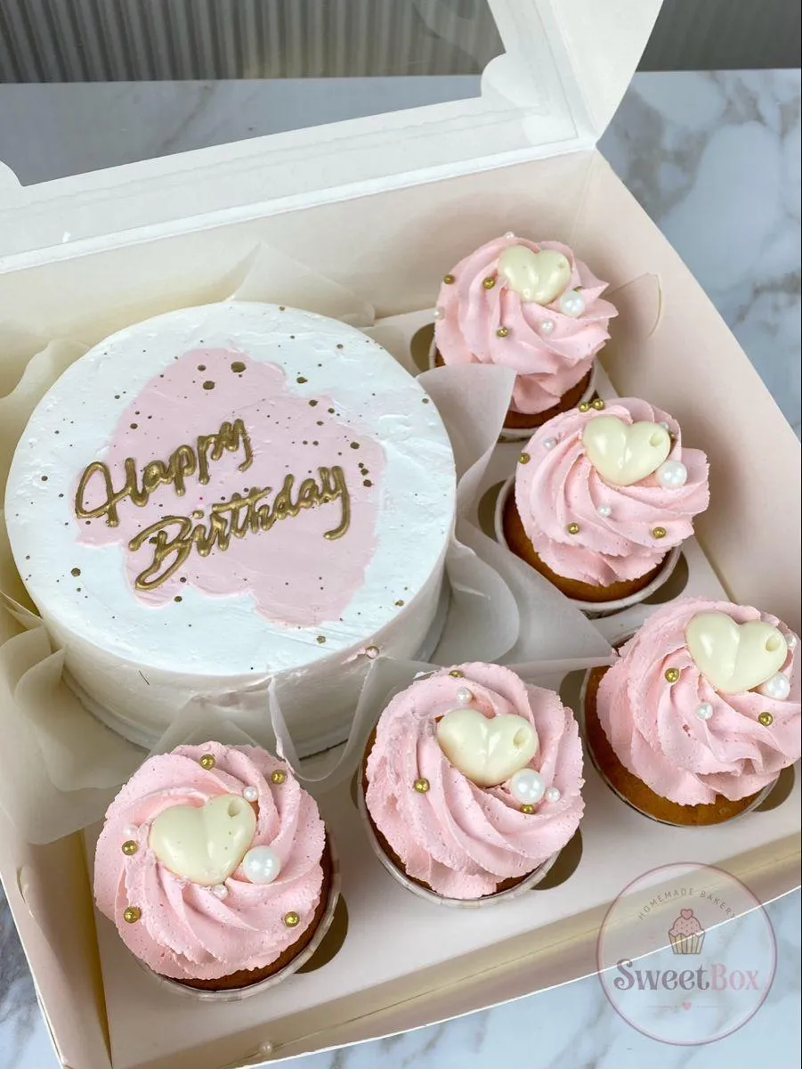 Gift box with a white Happy Birthday bento cake and five pink cupcakes topped with white chocolate hearts and pearls