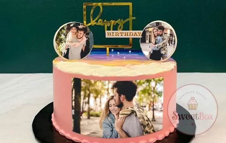 Pink cake with an edible couple photo around the side, two round photo toppers and a gold happy birthday topper