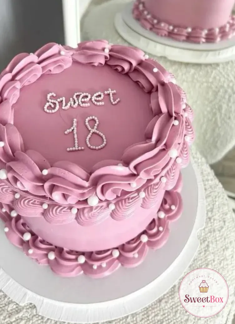 Mauve vintage-style cake with ruffled piped borders, white sugar pearls and Sweet 18 written in tiny pearls on top